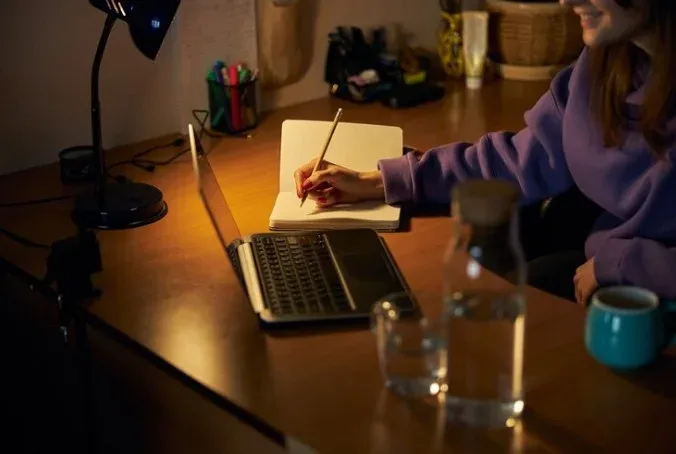 A writer brainstorming ideas at a cozy desk, showcasing the creativity of an SEO content writing agency at work.